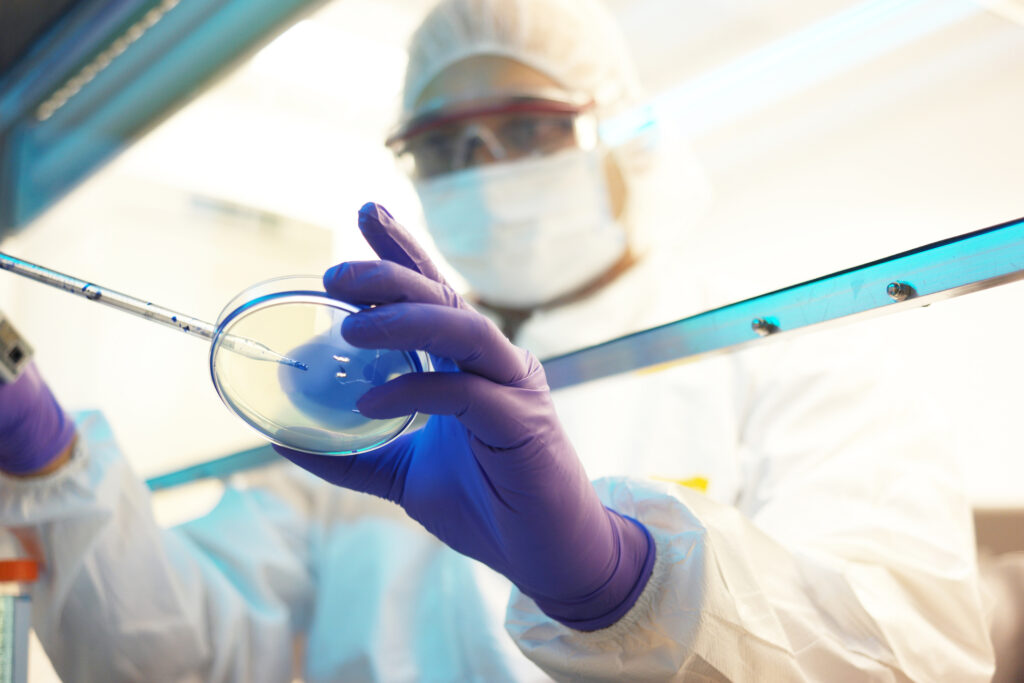 A scientist in a lab with a clear trey